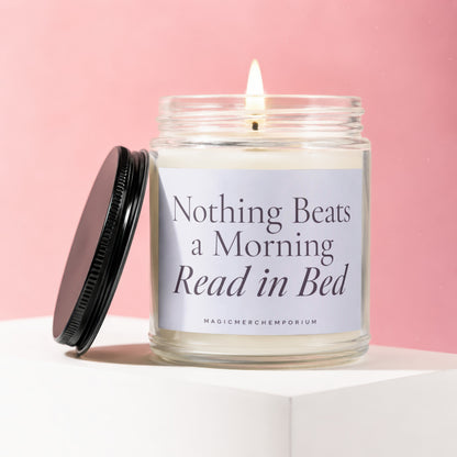 Candle with text "Nothing Beats a Morning Read in Bed" on a pink background.
