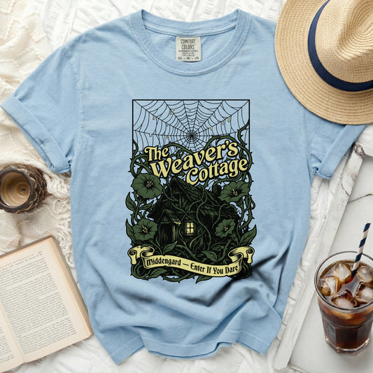Light blue t-shirt with "The Weaver's Cottage" and "Middengard - Enter If You Dare" graphic.