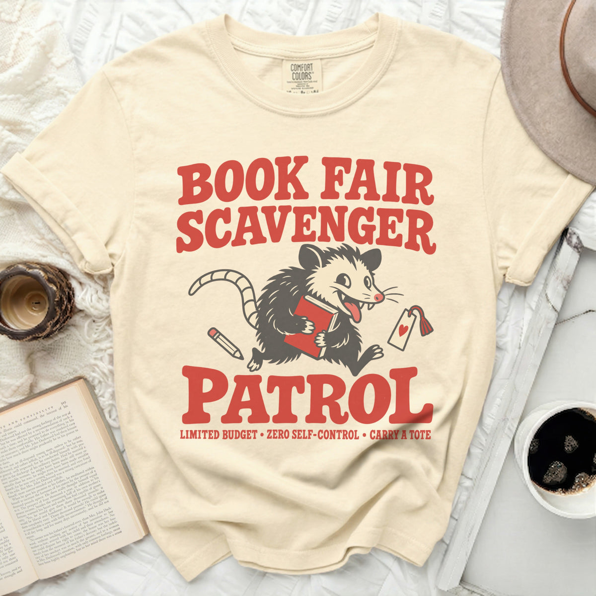 Cream t-shirt with "Book Fair Scavenger Patrol" and a possum graphic.