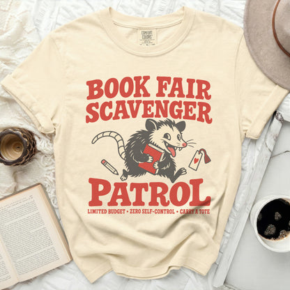 Cream t-shirt with "Book Fair Scavenger Patrol" and a possum graphic.