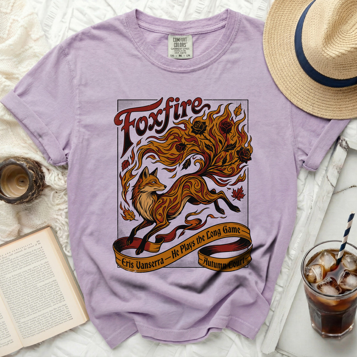 Purple t-shirt with a foxfire design and text: "Foxfire Eris Vanserra - He Plays the Long Game Autumn Court".