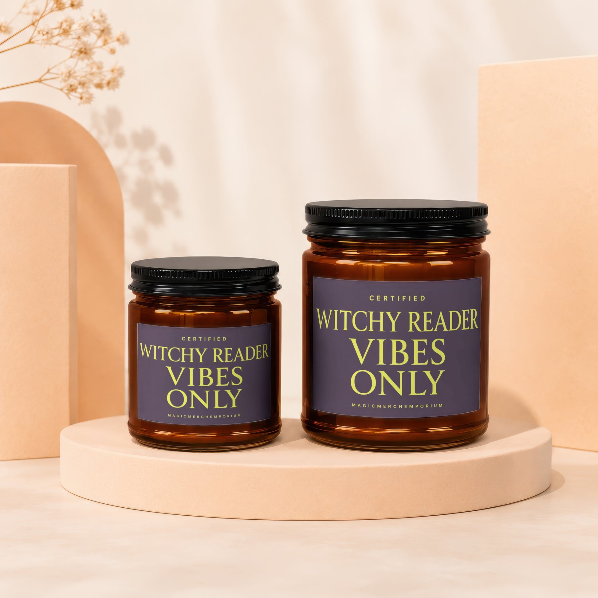Amber glass candles with black lids labeled "Certified Witchy Reader Vibes Only".