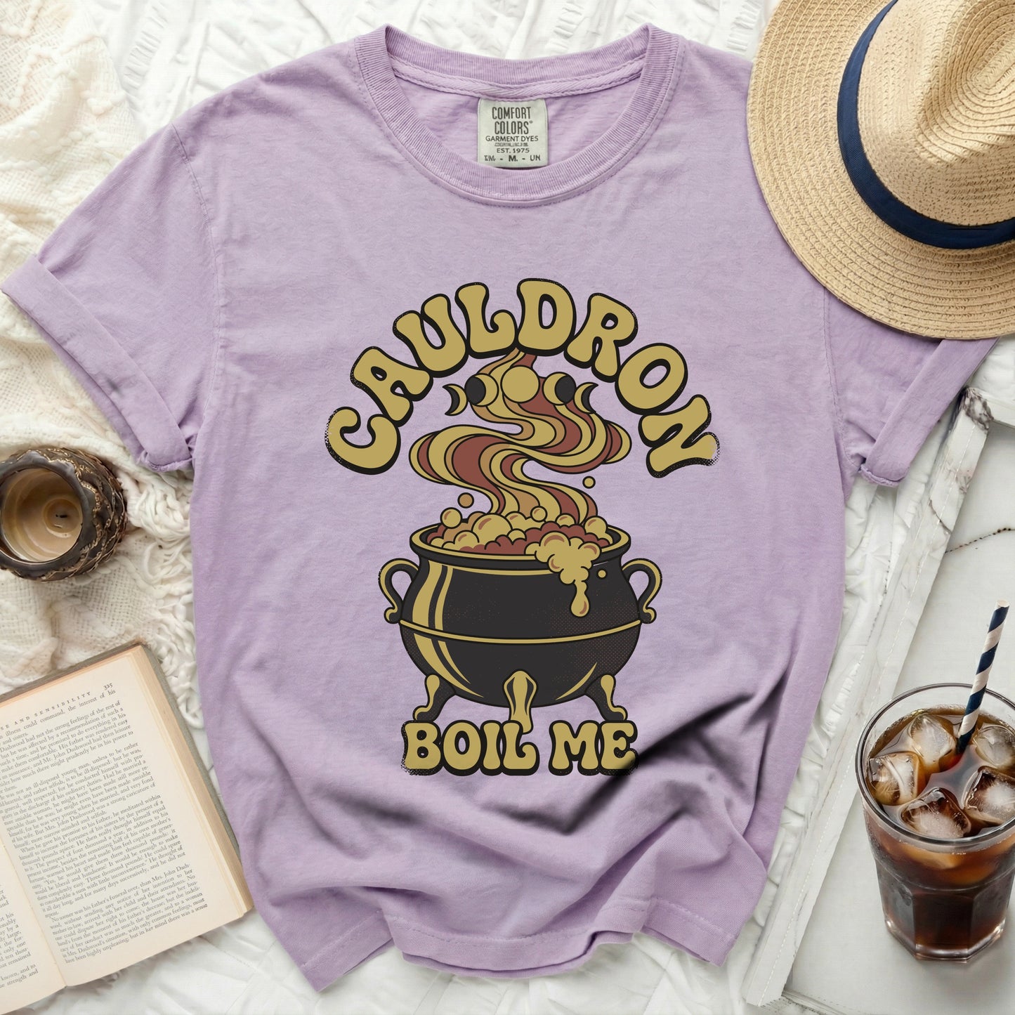 Lavender t-shirt with "Cauldron Boil Me" graphic and a cauldron.