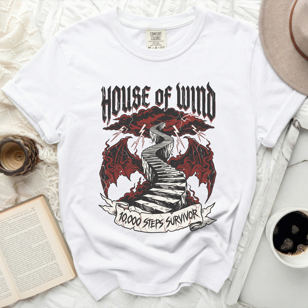 White t-shirt with "House of Wind" and "10,000 Steps Survivor" graphic.