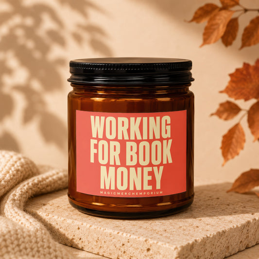 Candle with text "WORKING FOR BOOK MONEY" and "MAGICMERCHUMPORIUM".