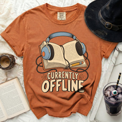 Orange t-shirt with "Currently Offline" text and headphones over an open book graphic.