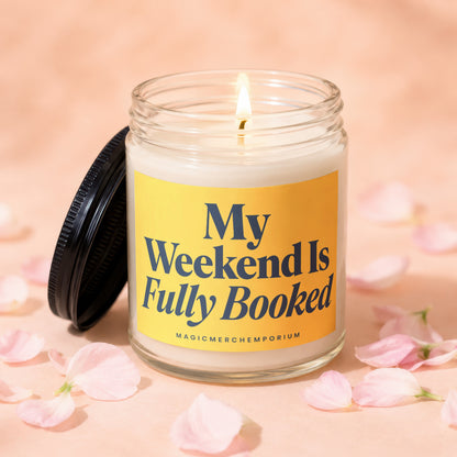 Candle with yellow label reading "My Weekend Is Fully Booked".