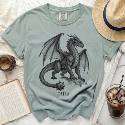 Light blue t-shirt with a black and gray dragon graphic and "TAIRN" text.