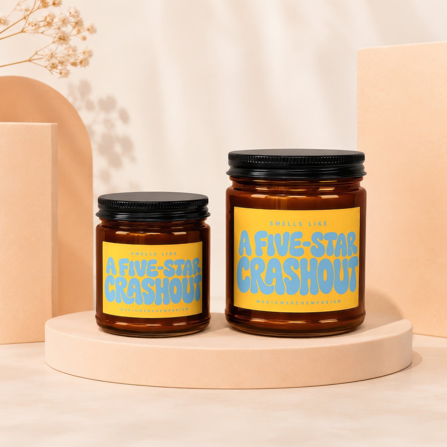 Two amber glass candles with yellow labels reading "Smells Like A Five-Star Crashout".