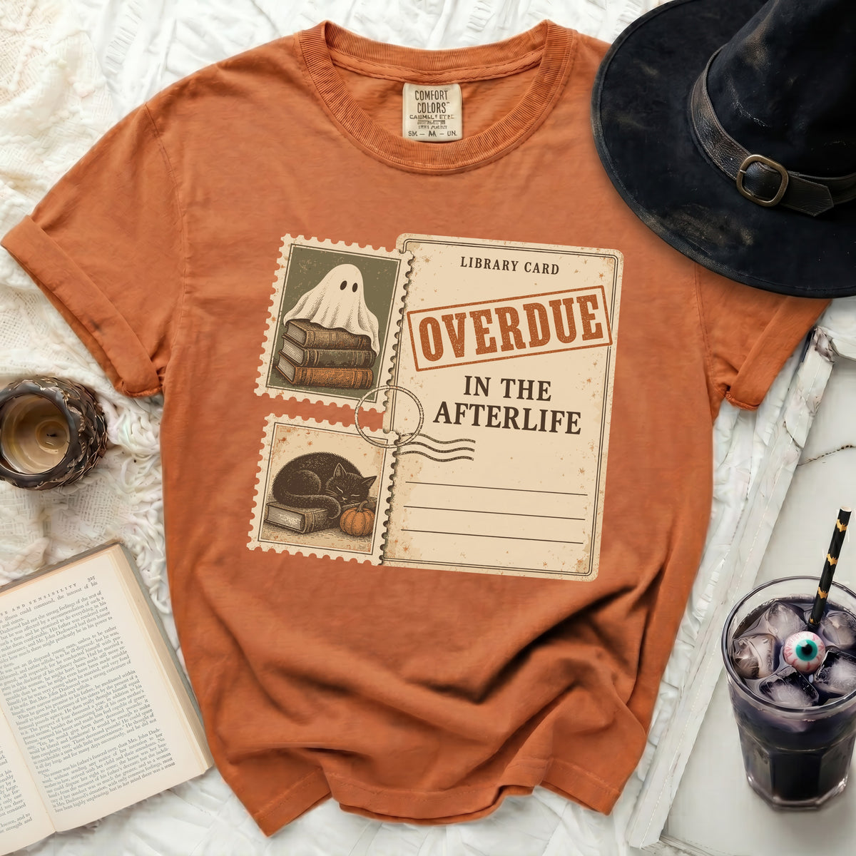 Orange t-shirt with "Overdue in the Afterlife" library card design.