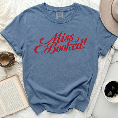 Blue t-shirt with red script text "Miss Booked!"