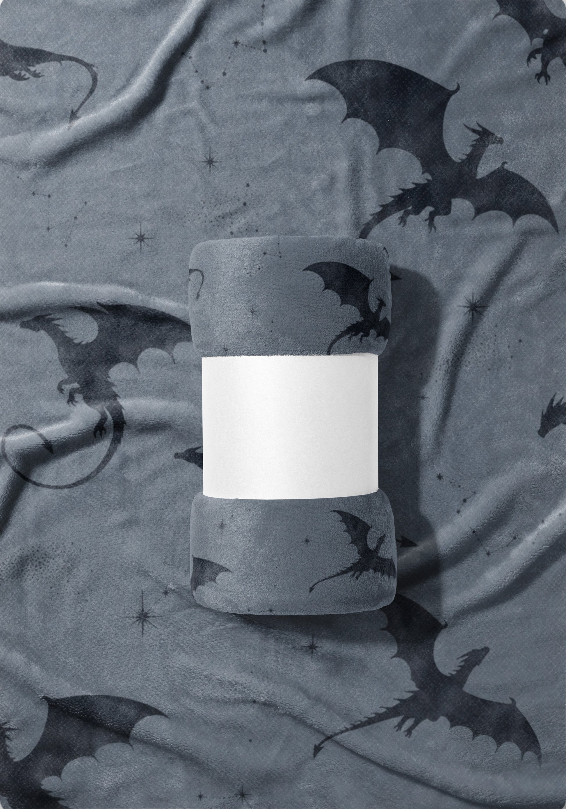 Rolled grey blanket with all-over black dragon and star constellation print.