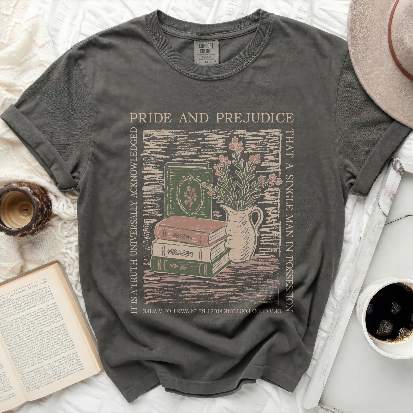Pride and Prejudice graphic tee with stacked books and flowers.