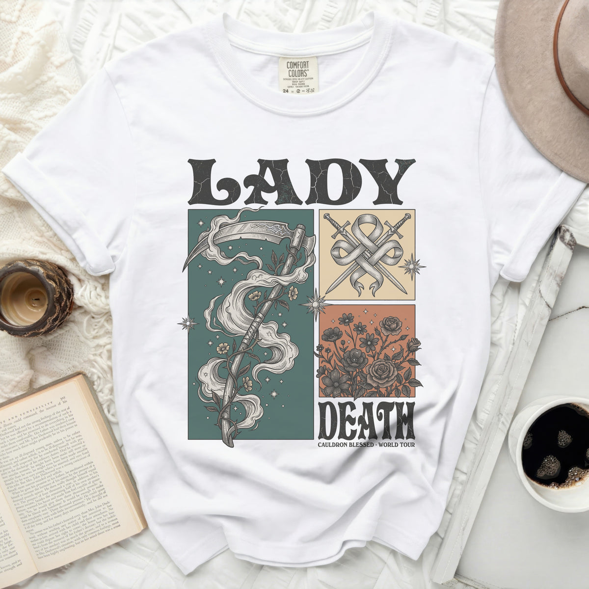 White t-shirt with "LADY DEATH" graphic, scythe, swords, and floral designs.