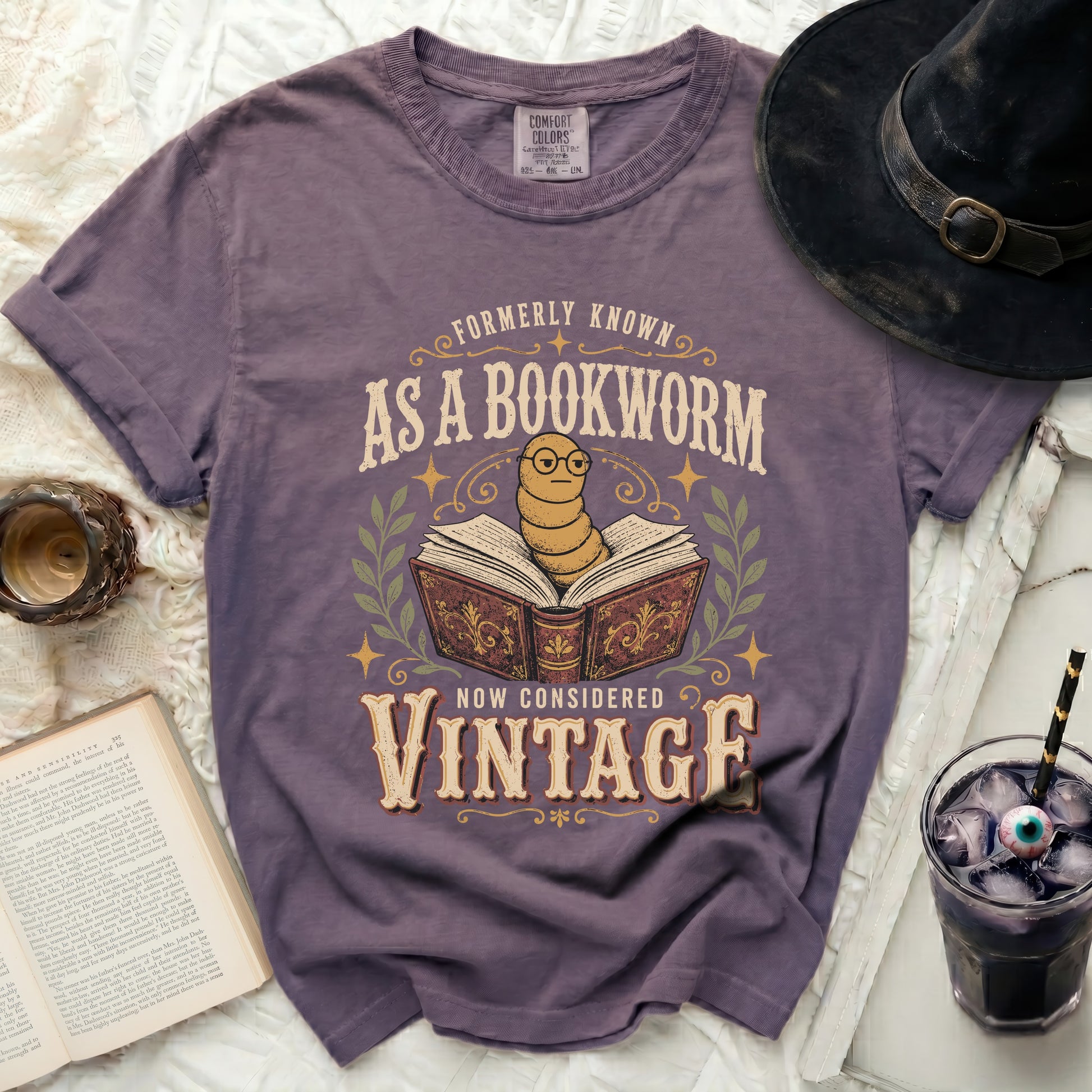 Purple t-shirt with "Formerly Known as a Bookworm Now Considered Vintage" graphic.