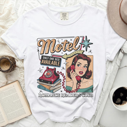 White t-shirt with vintage "Motel Only One Bed Available" graphic and woman on phone.