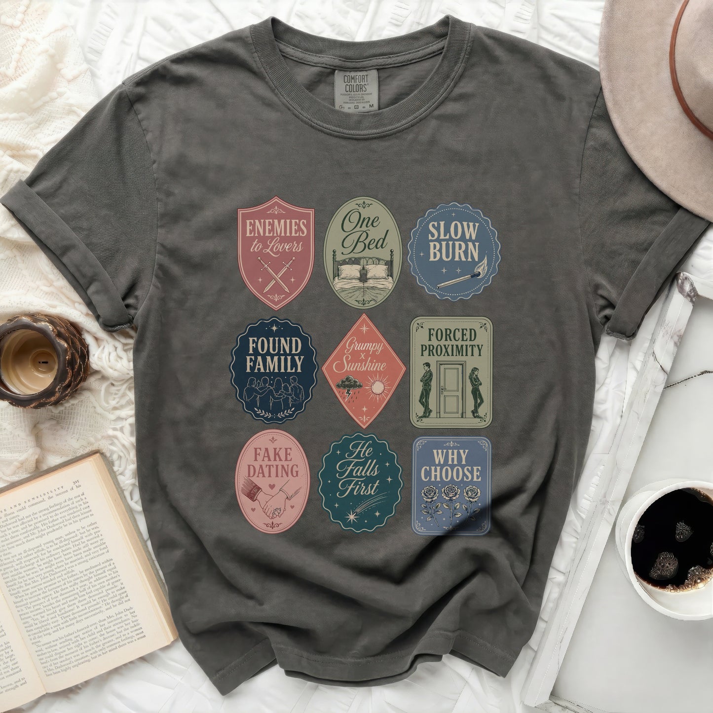 T-shirt with nine embroidered patches featuring bookish phrases and icons.