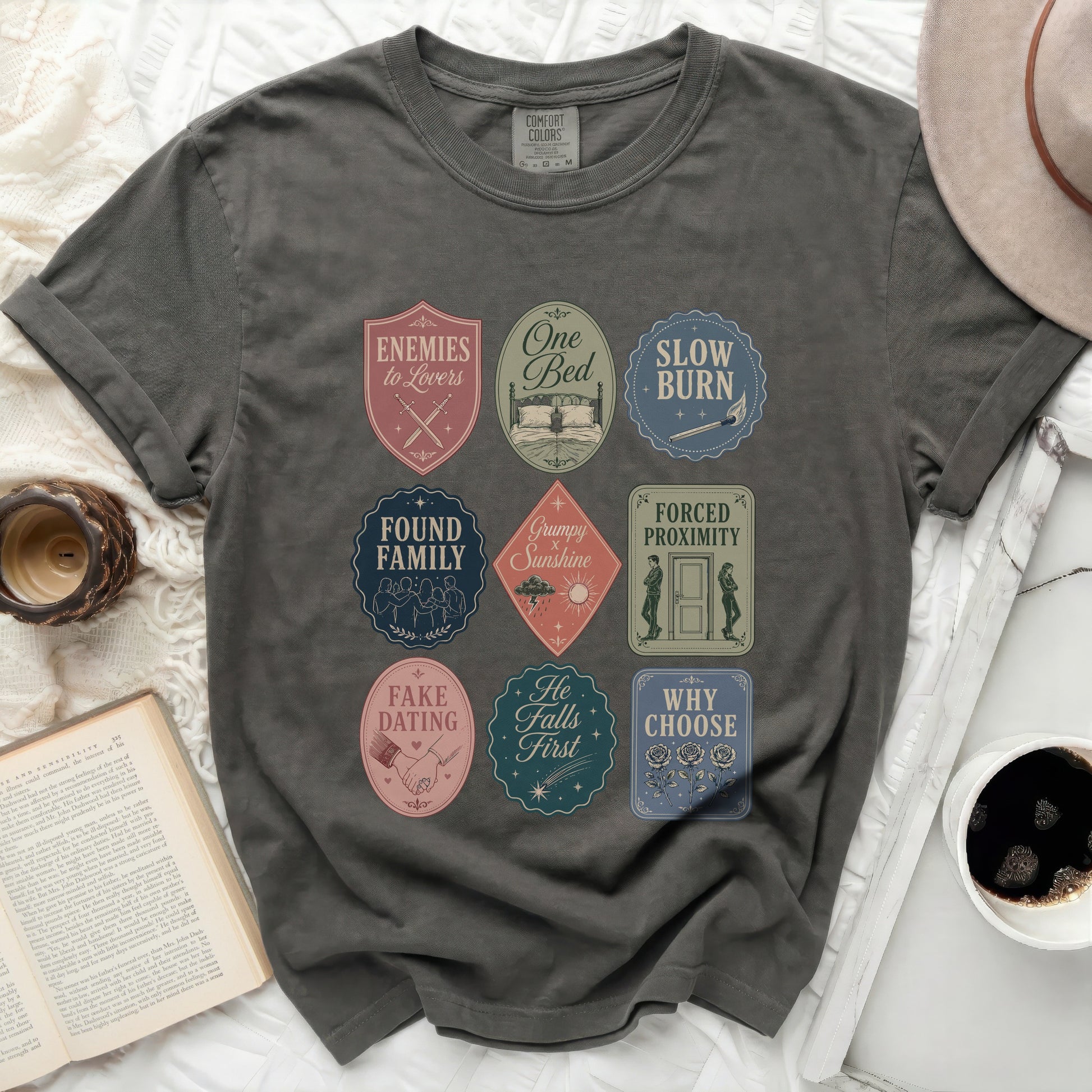 T-shirt with nine embroidered patches featuring bookish phrases and icons.