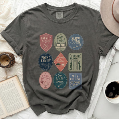 T-shirt with nine embroidered patches featuring bookish phrases and icons.