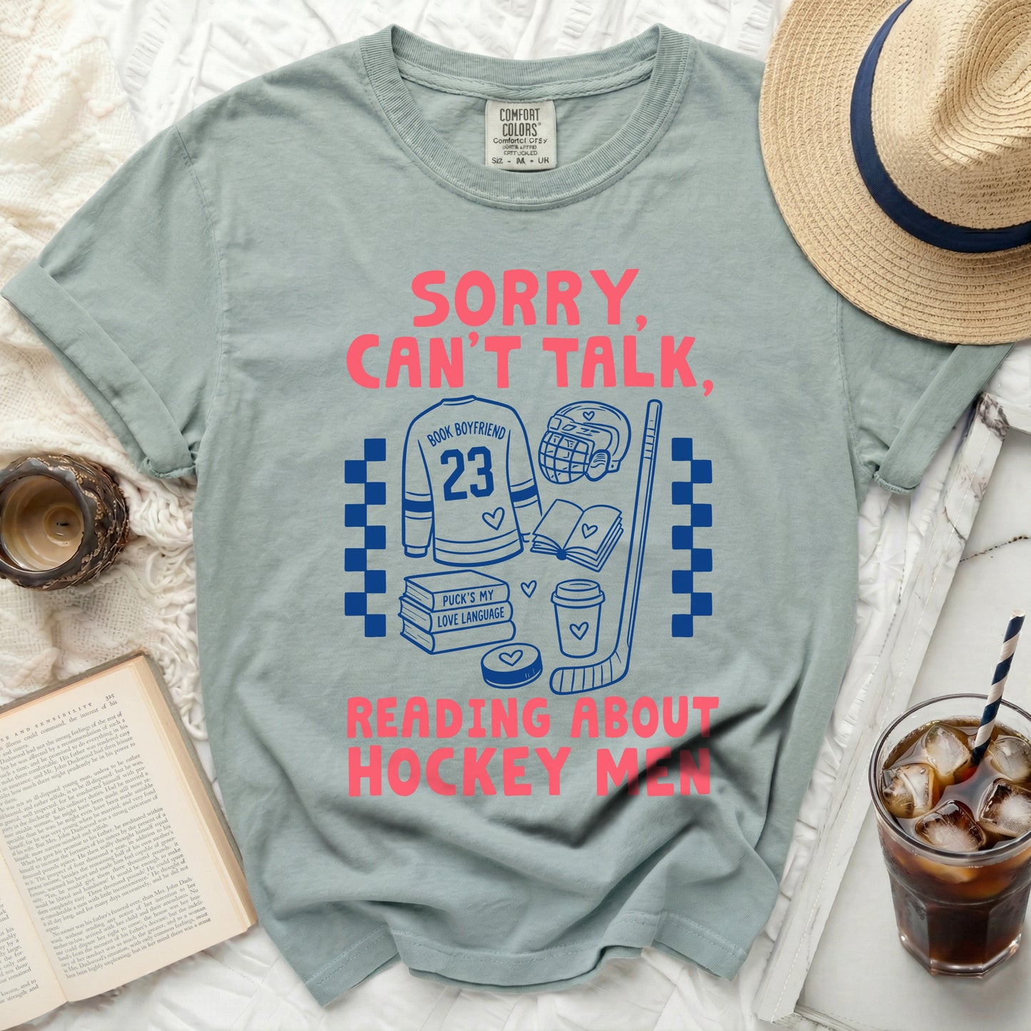 Comfort Colors t-shirt with hockey and book graphic and text.