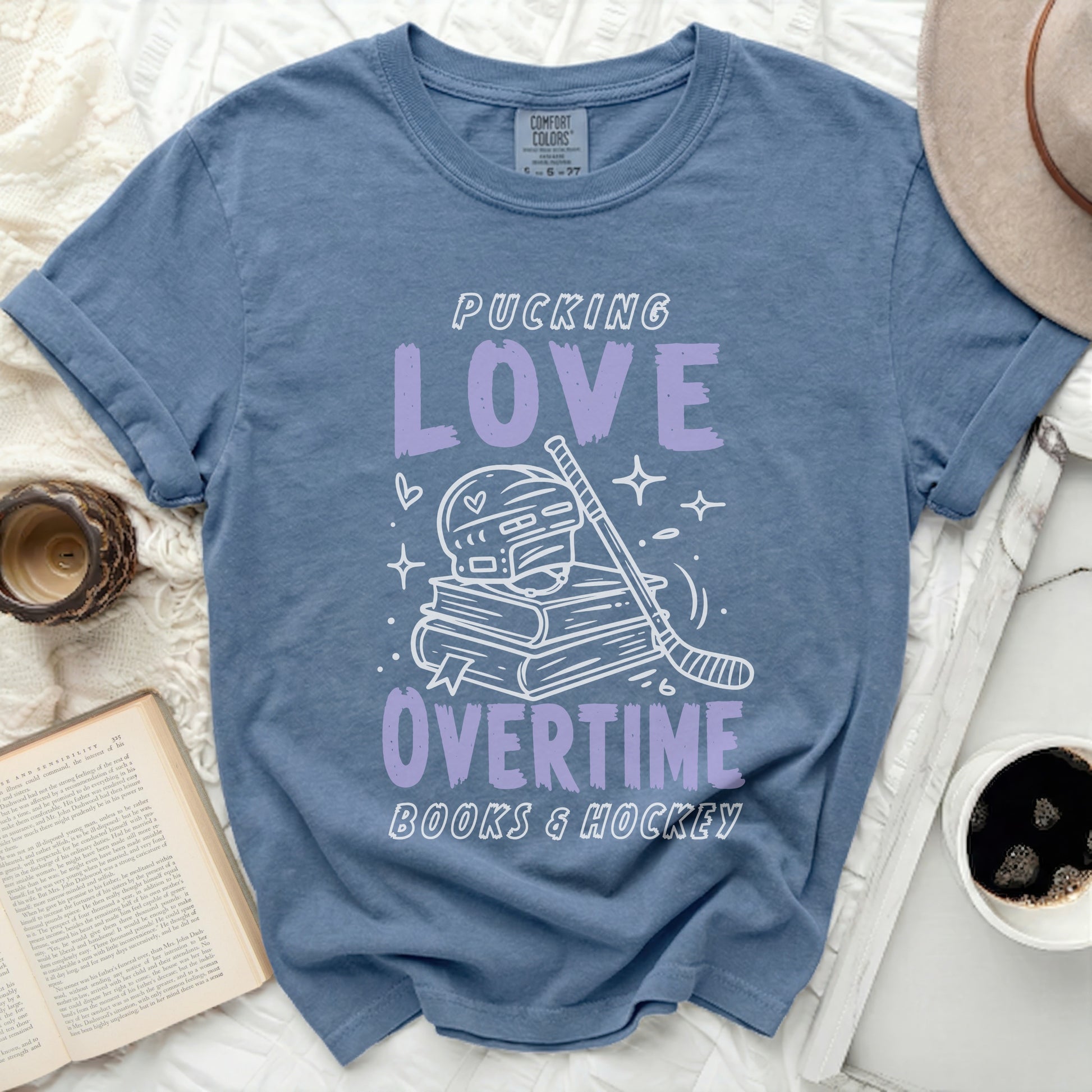 Purple t-shirt with "Pucking Love Overtime Books & Hockey" text.
