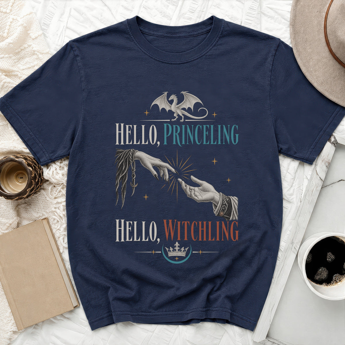 Navy t-shirt with dragon and outstretched hands graphic, text "HELLO, PRINCELING HELLO, WITCHLING".