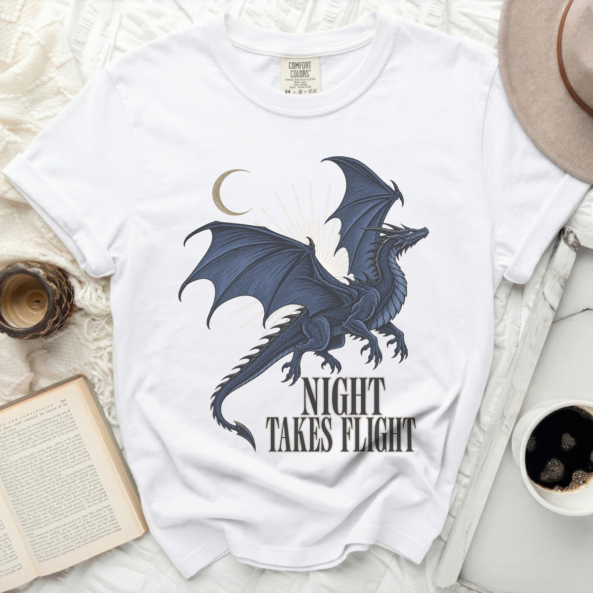 White t-shirt with a blue dragon graphic and "Night Takes Flight" text.