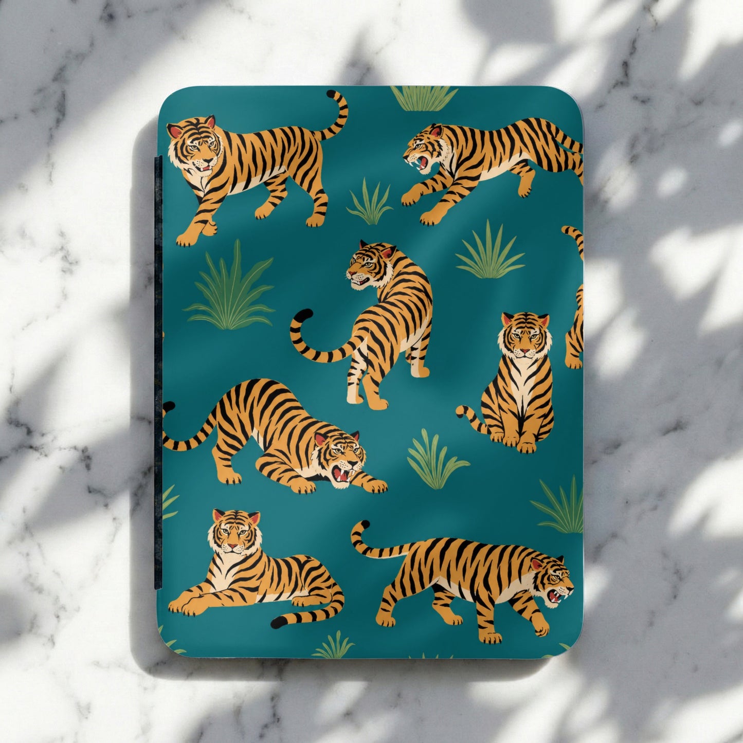 Territorial tigers on a teal background with lush greenery and shadows.