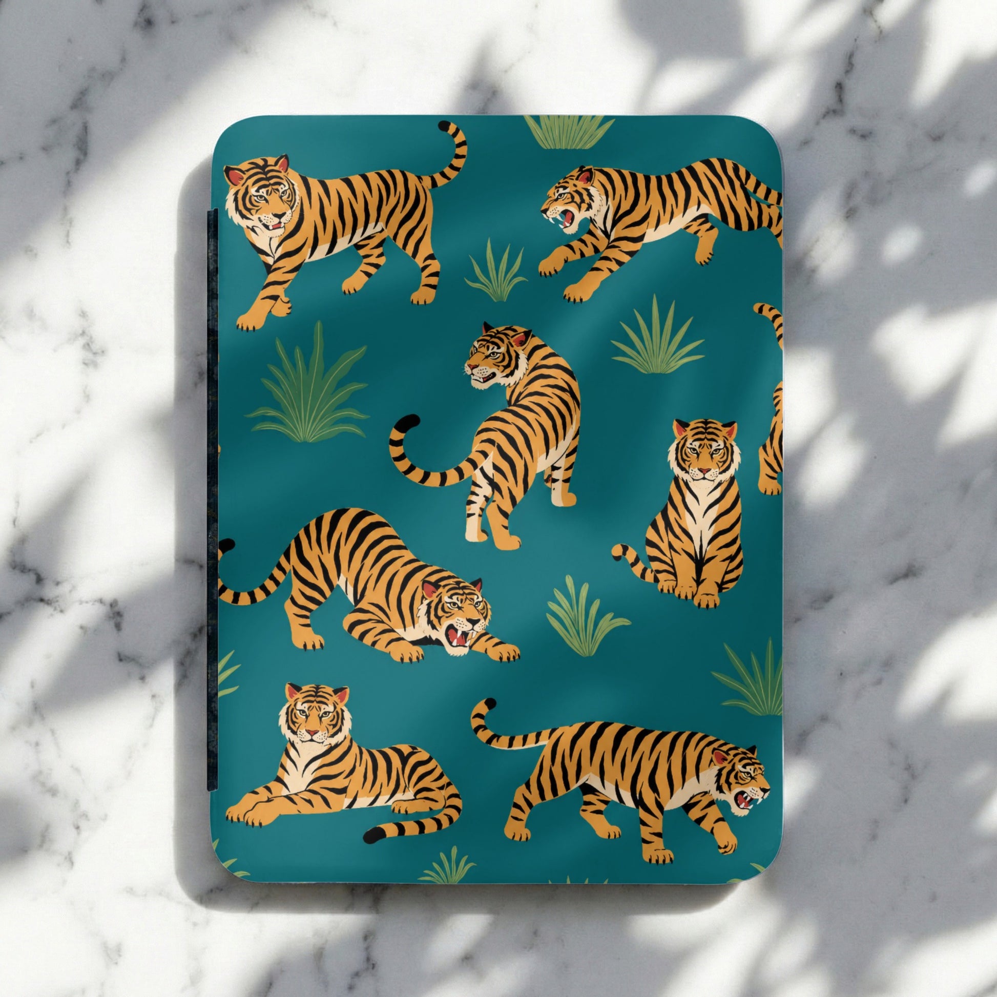 Territorial tigers on a teal background with lush greenery and shadows.
