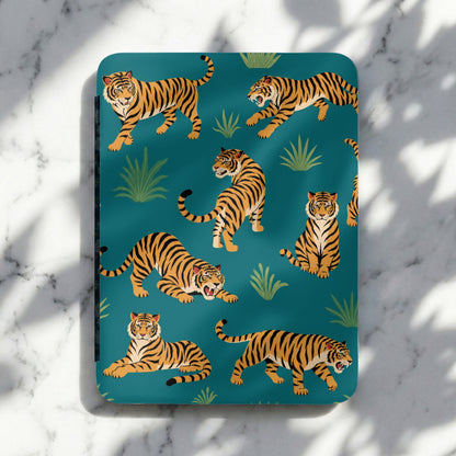 Territorial tigers on a teal background with lush greenery and shadows.