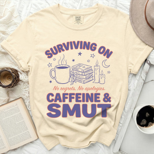 Surviving on caffeine and smut t-shirt with books, coffee, and candles.
