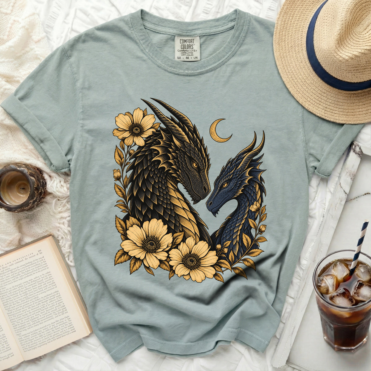 Light blue t-shirt with two dragons and yellow flowers, size M.
