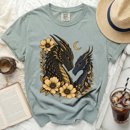 Light blue t-shirt with two dragons and yellow flowers, size M.
