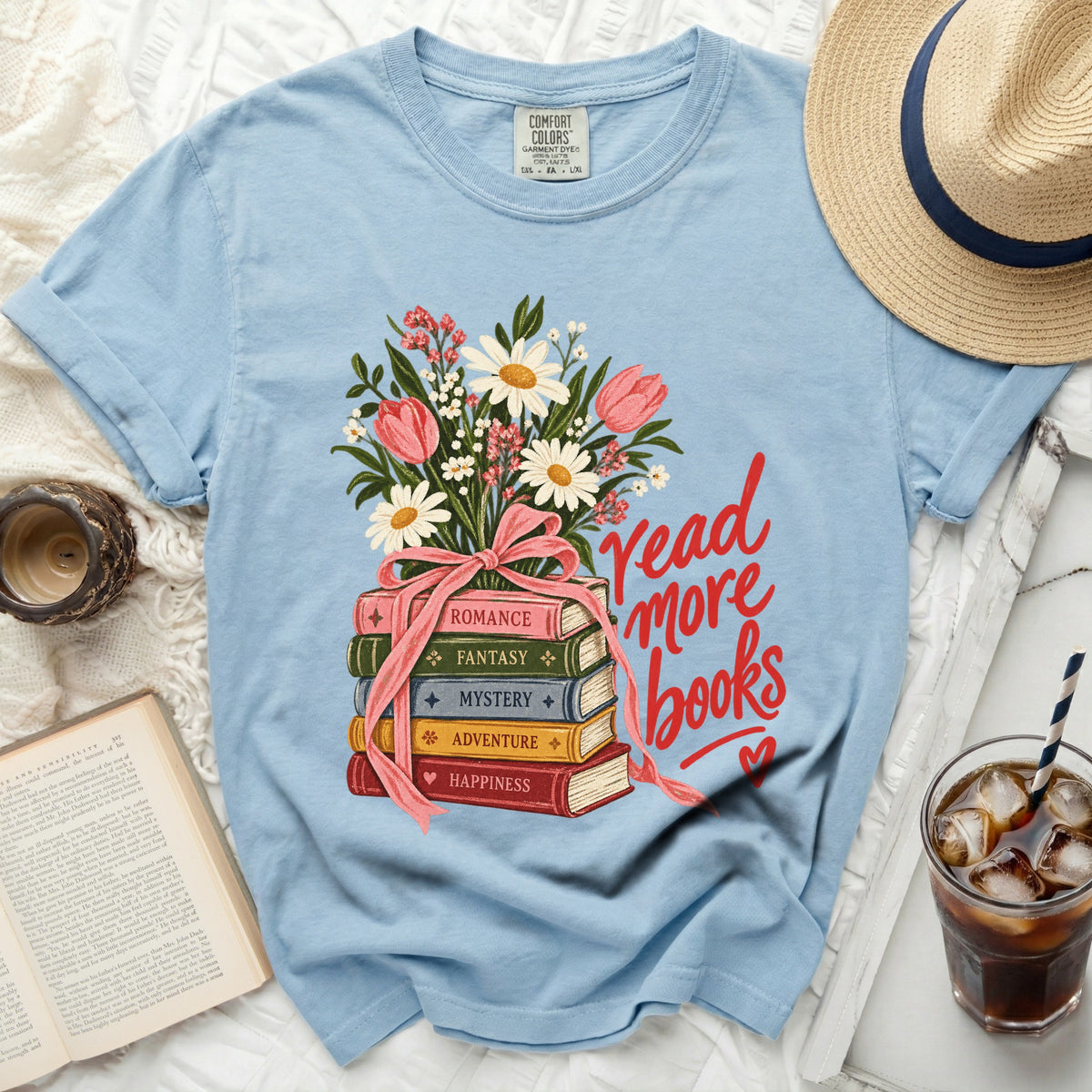 Light blue t-shirt with "read more books" graphic and stack of genre books.