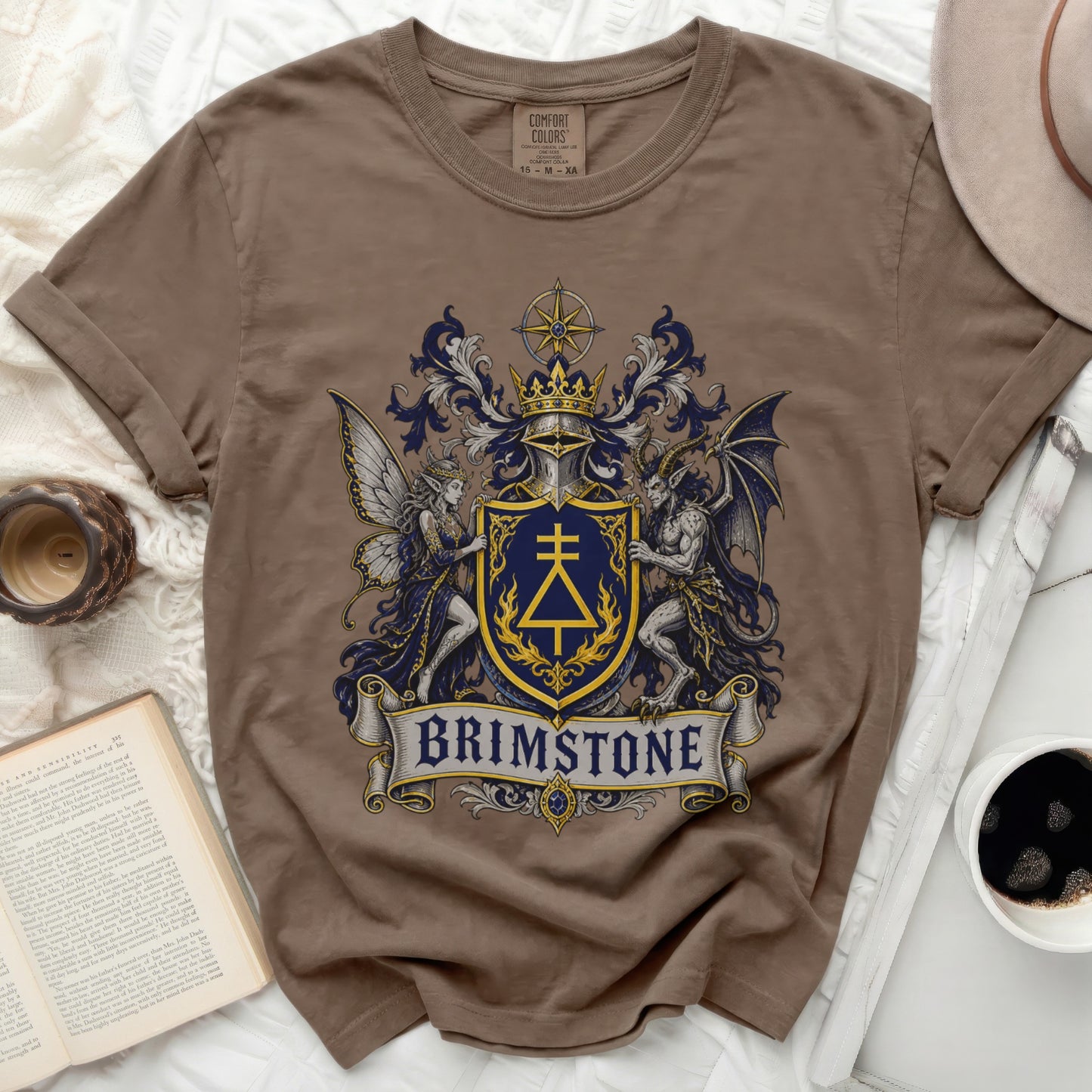 Brown t-shirt with a gothic crest featuring a dragon, fairy, and the word "BRIMSTONE".