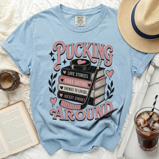Light blue t-shirt with "Pucking Around" and romance novel titles.