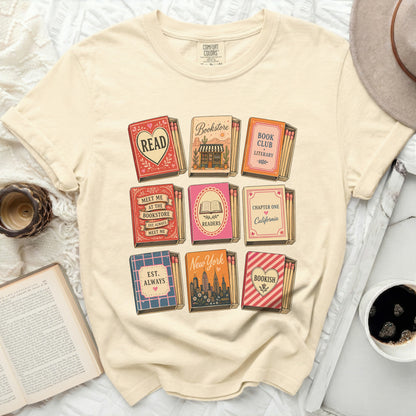 T-shirt with matchbook designs featuring book-related text and city names.