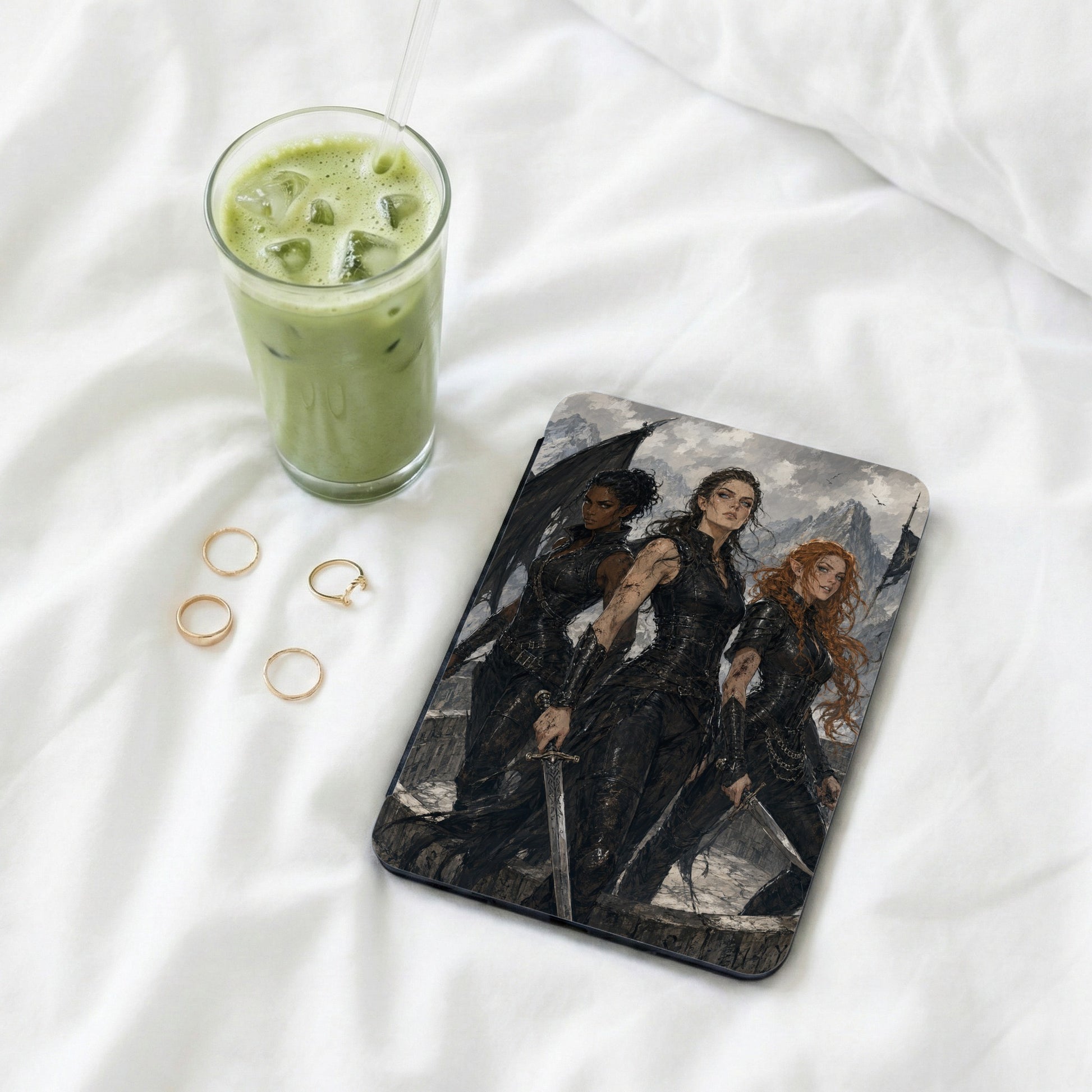 Three women in dark armor with swords stand before a mountain landscape on a tablet.