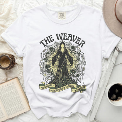 White t-shirt with "The Weaver" design, featuring a robed figure and spiderweb.