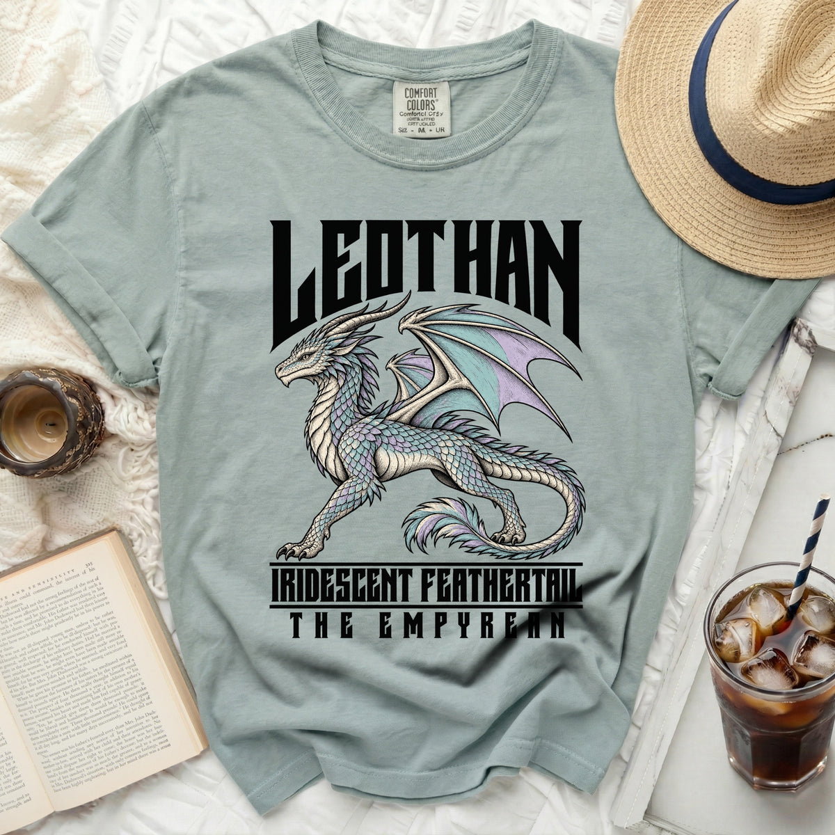 Light blue t-shirt with a graphic of a dragon and the text "LEOTHAN IRIDESCENT FEATHERTAIL THE EMPYREAN".