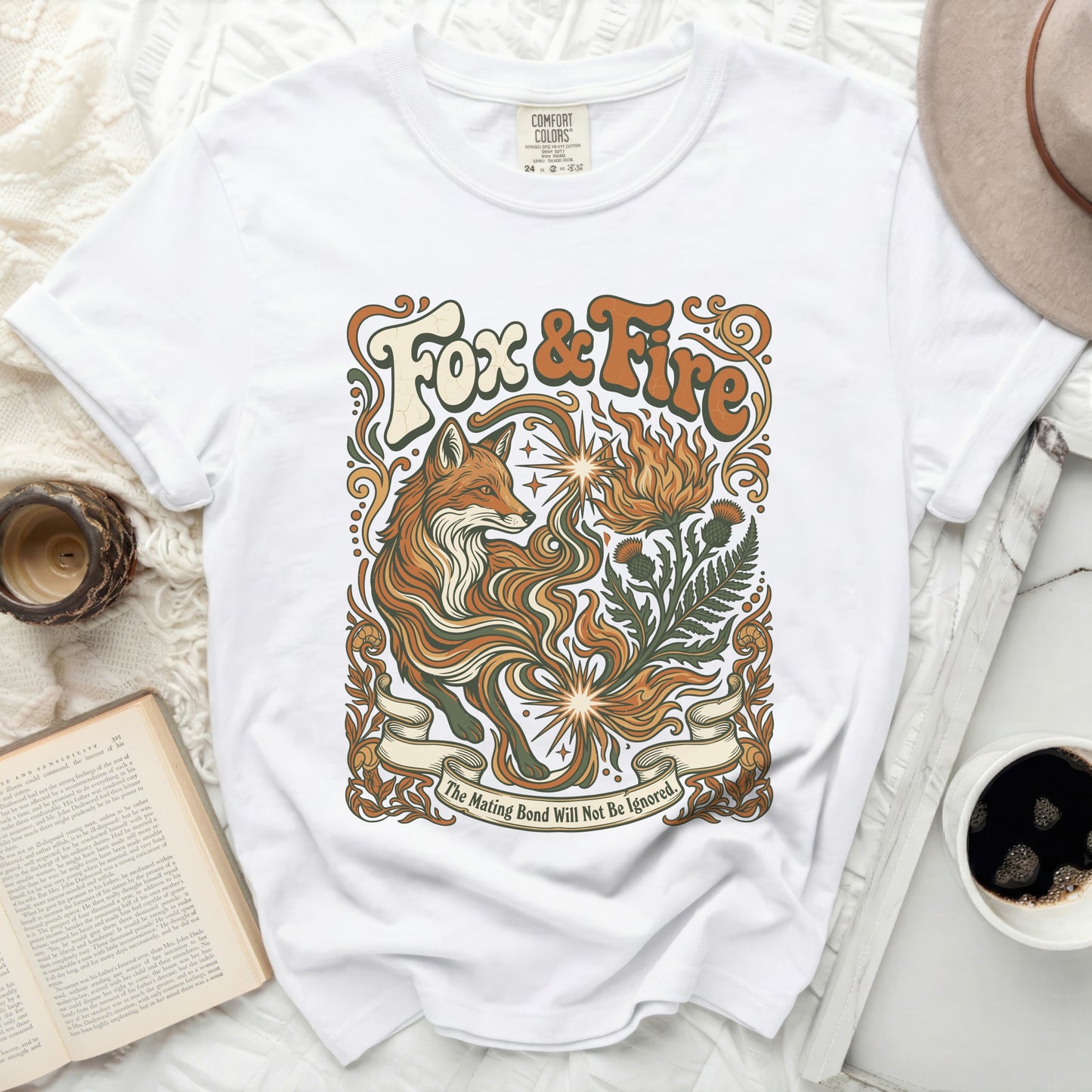 White t-shirt with "Fox & Fire" graphic and fox and floral design.