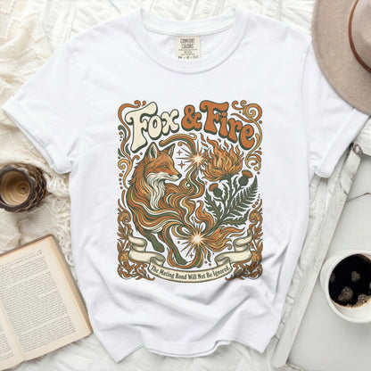 White t-shirt with "Fox & Fire" graphic and fox and floral design.