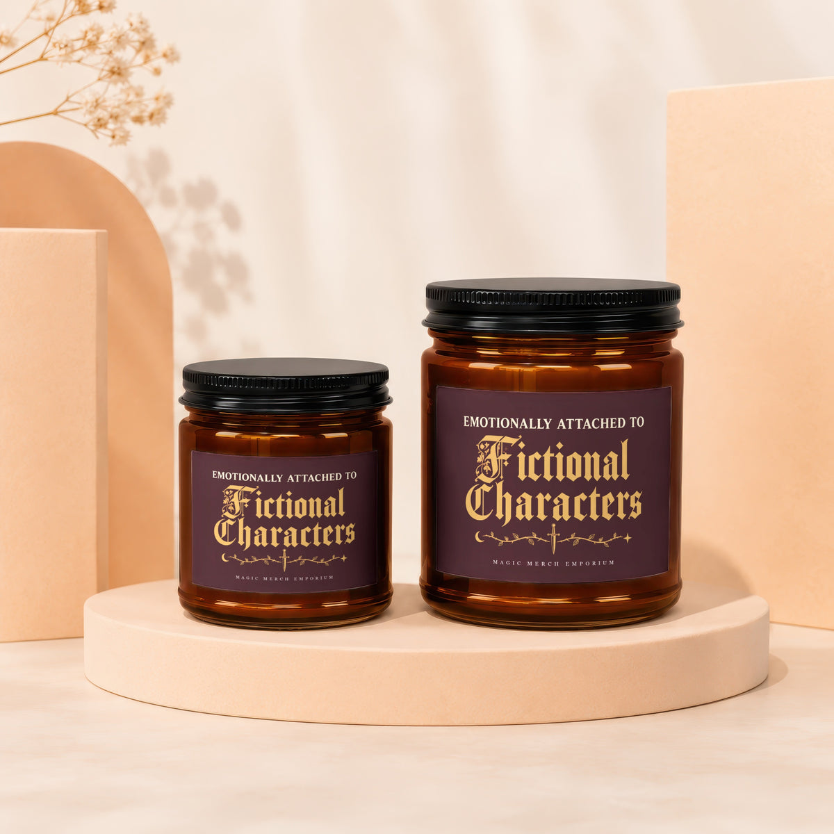 Two amber glass candles with black lids, labeled "Emotionally Attached to Fictional Characters".