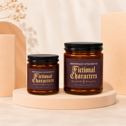Two amber glass candles with black lids, labeled "Emotionally Attached to Fictional Characters".