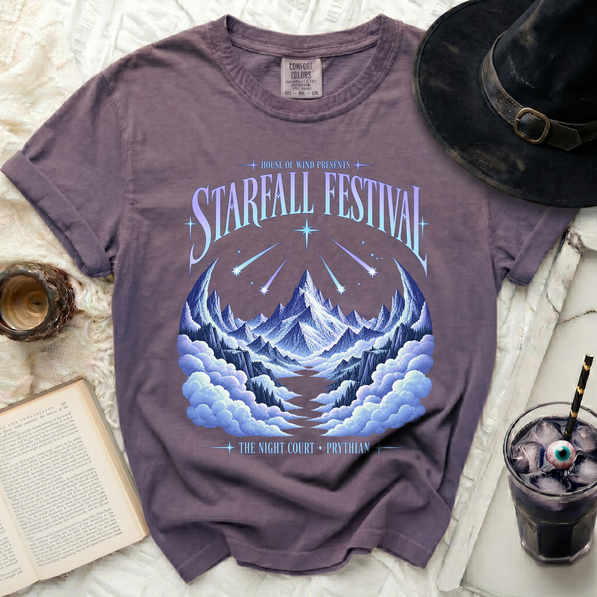 Purple t-shirt with "Starfall Festival" and mountain graphic.