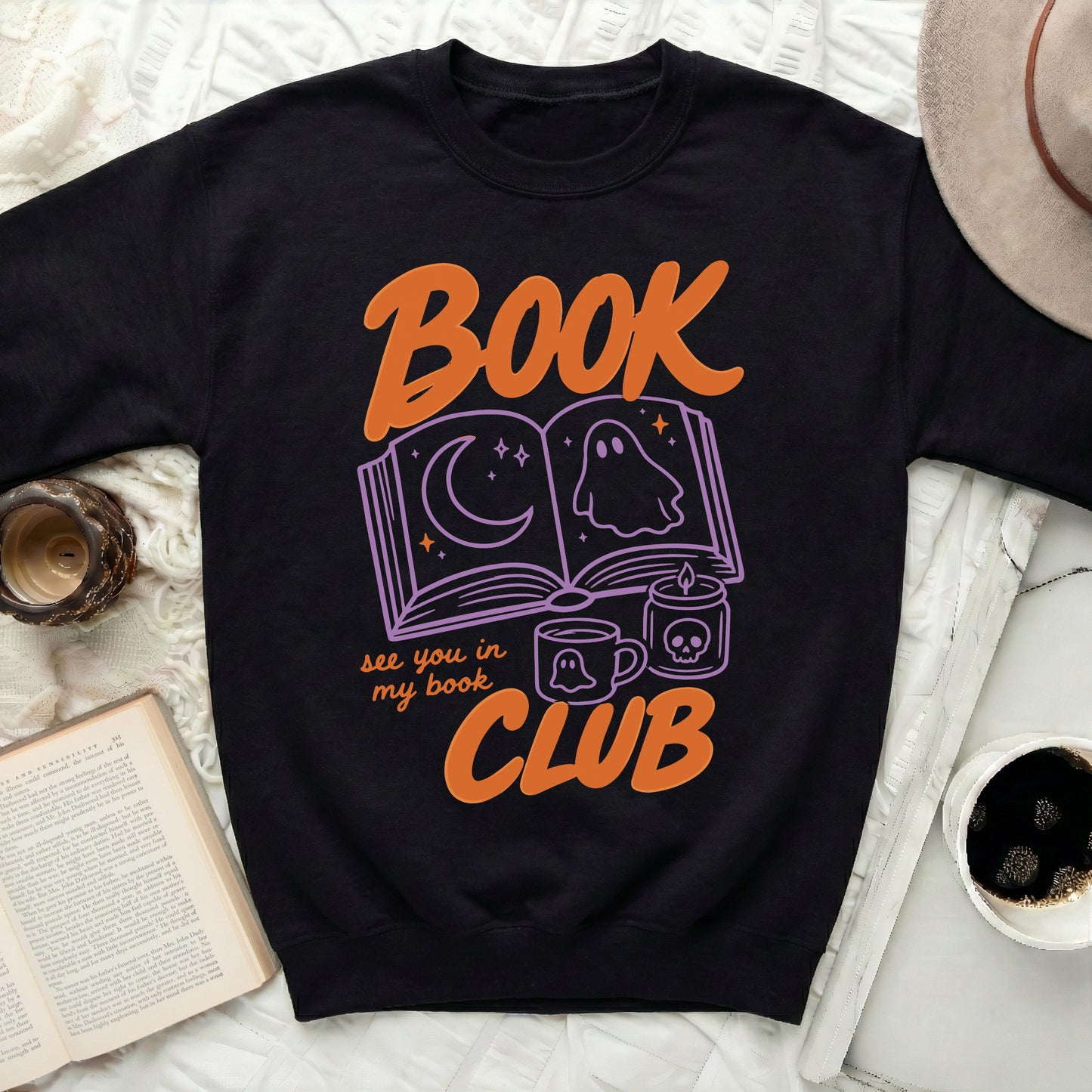 Black sweatshirt with "Book Club" text and Halloween-themed book graphic.