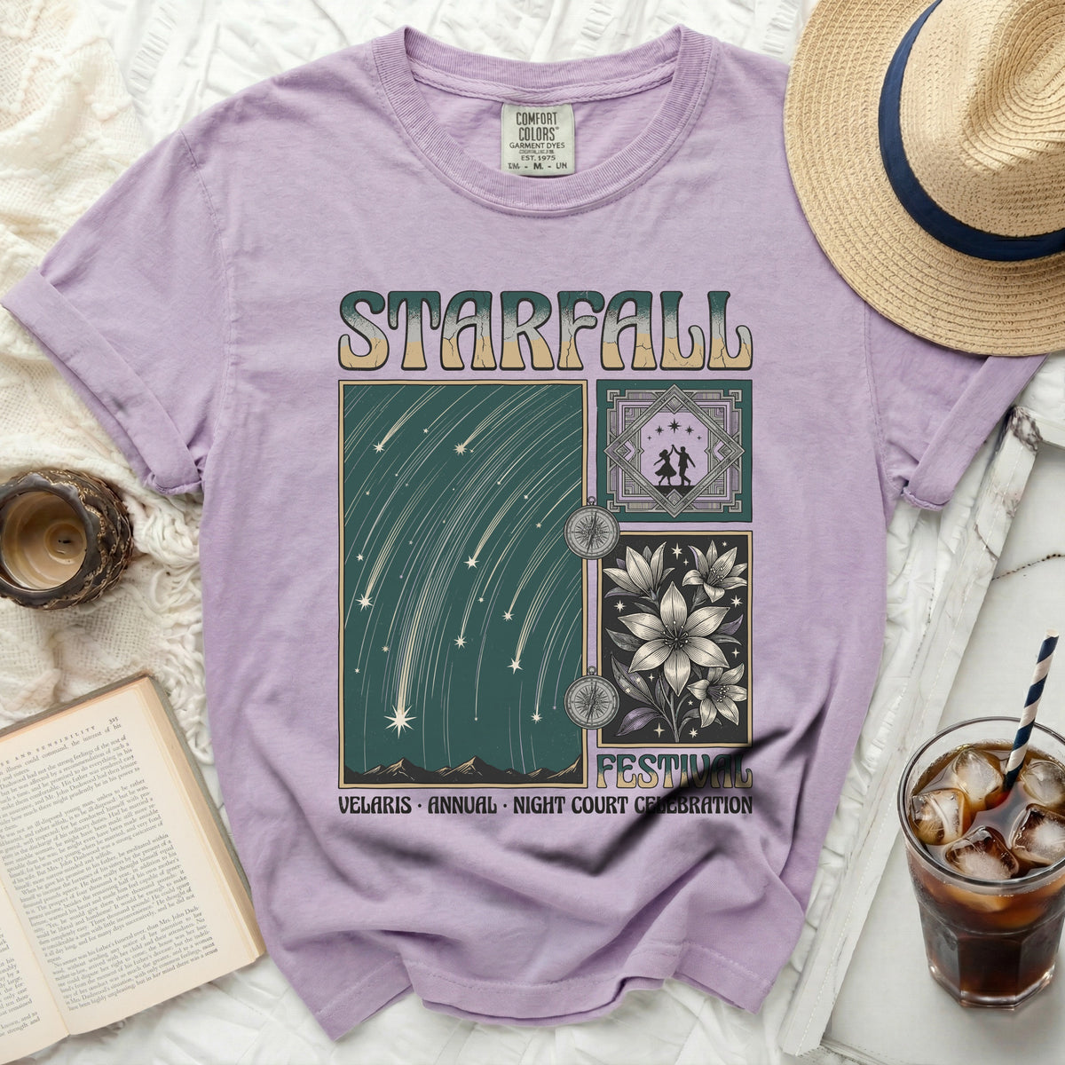 Purple t-shirt with "Starfall" graphic of shooting stars, flowers, and dancers.