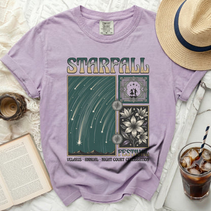 Purple t-shirt with "Starfall" graphic of shooting stars, flowers, and dancers.