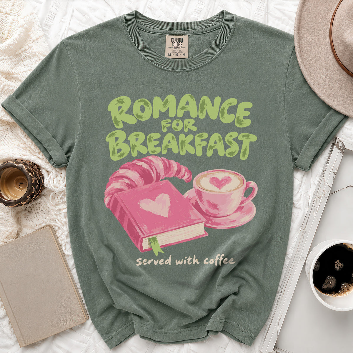 Green t-shirt with "Romance for Breakfast served with coffee" text and book graphic.