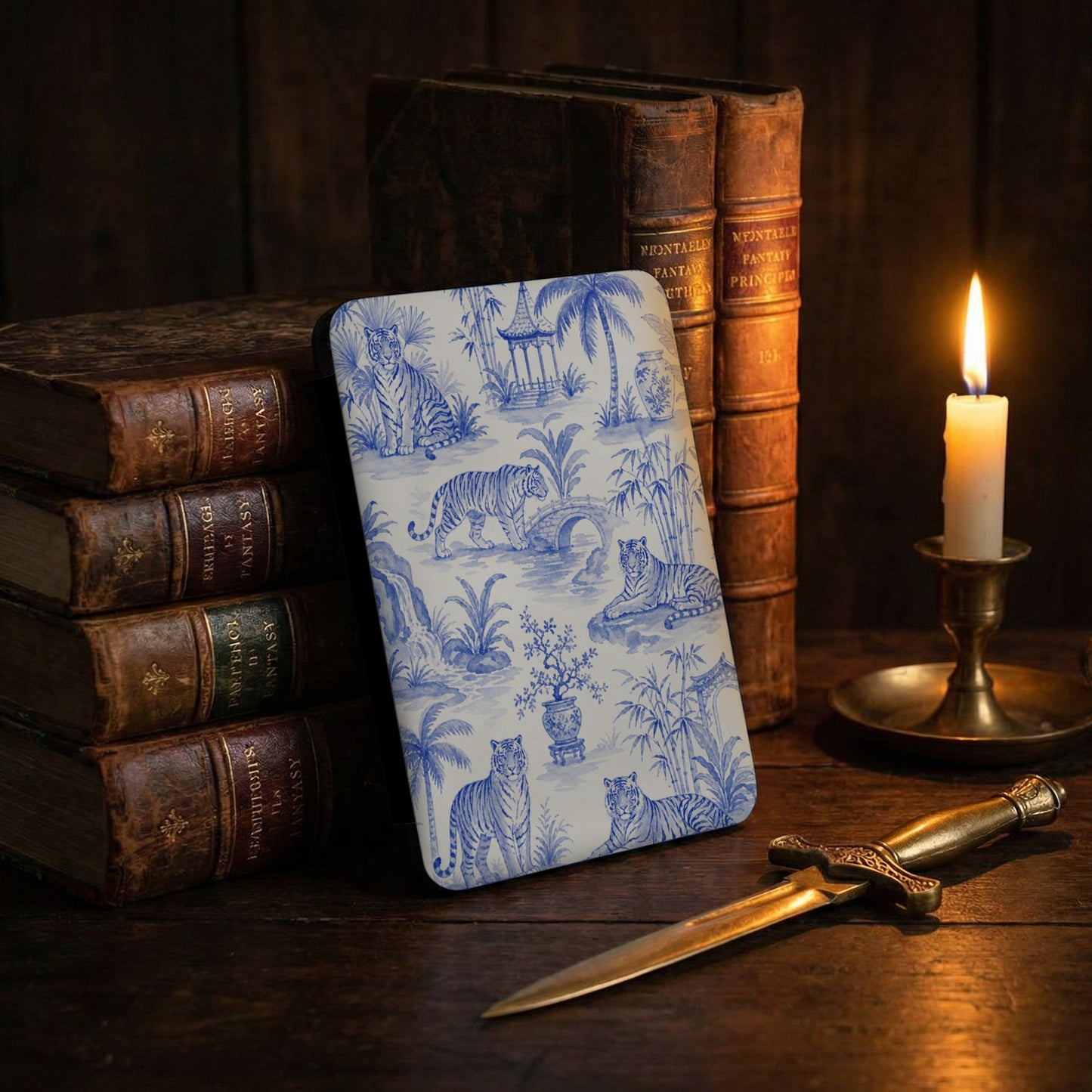 Blue and white toile pattern with tigers, pagodas, and tropical plants on a book cover.
